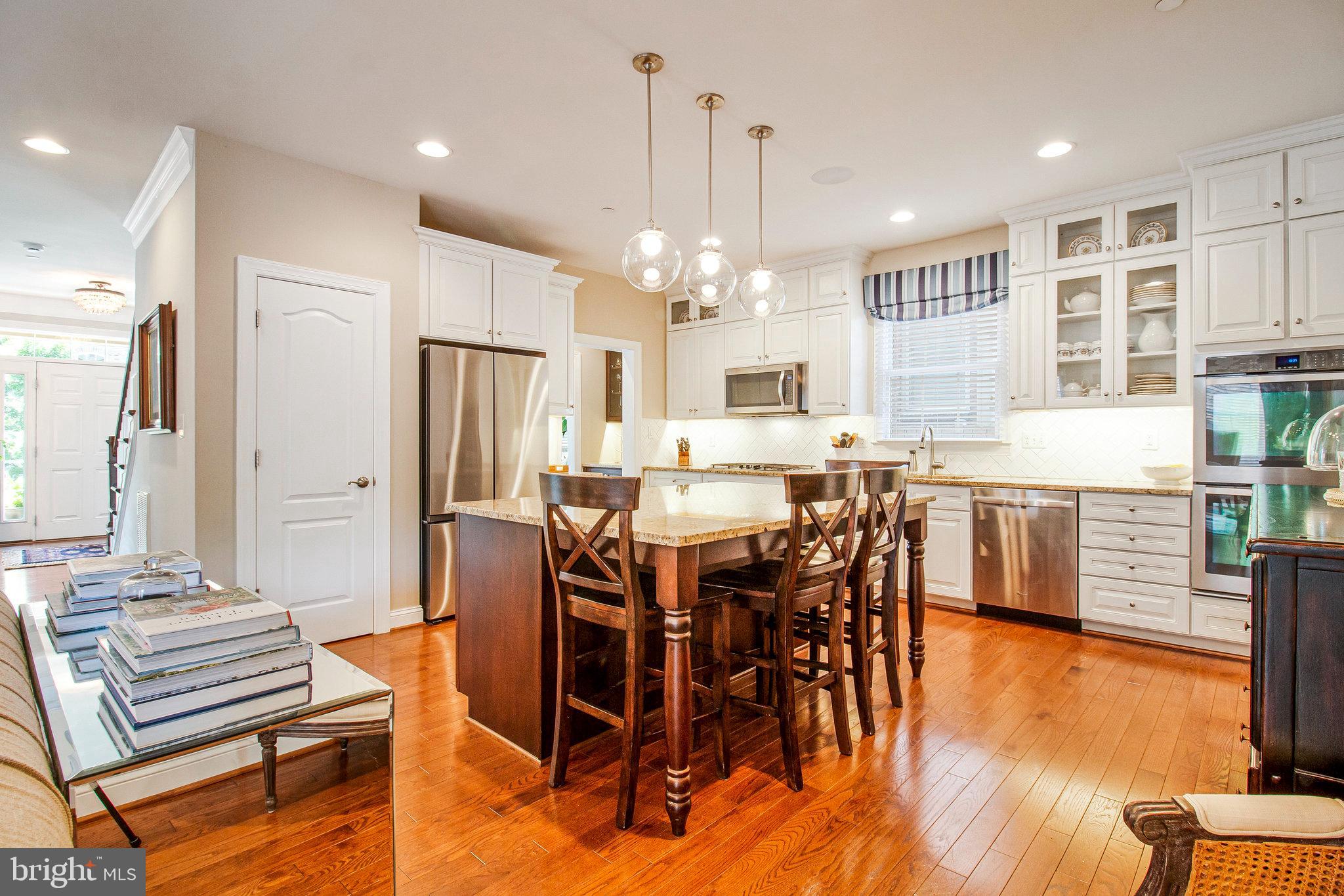 208 Beacon Place Northeast Washington, DC 20011 - Photo 5 of 48 a large kitchen with a table and chairs