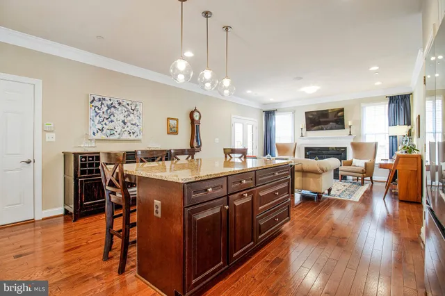 a kitchen with a sink appliances and wooden floor