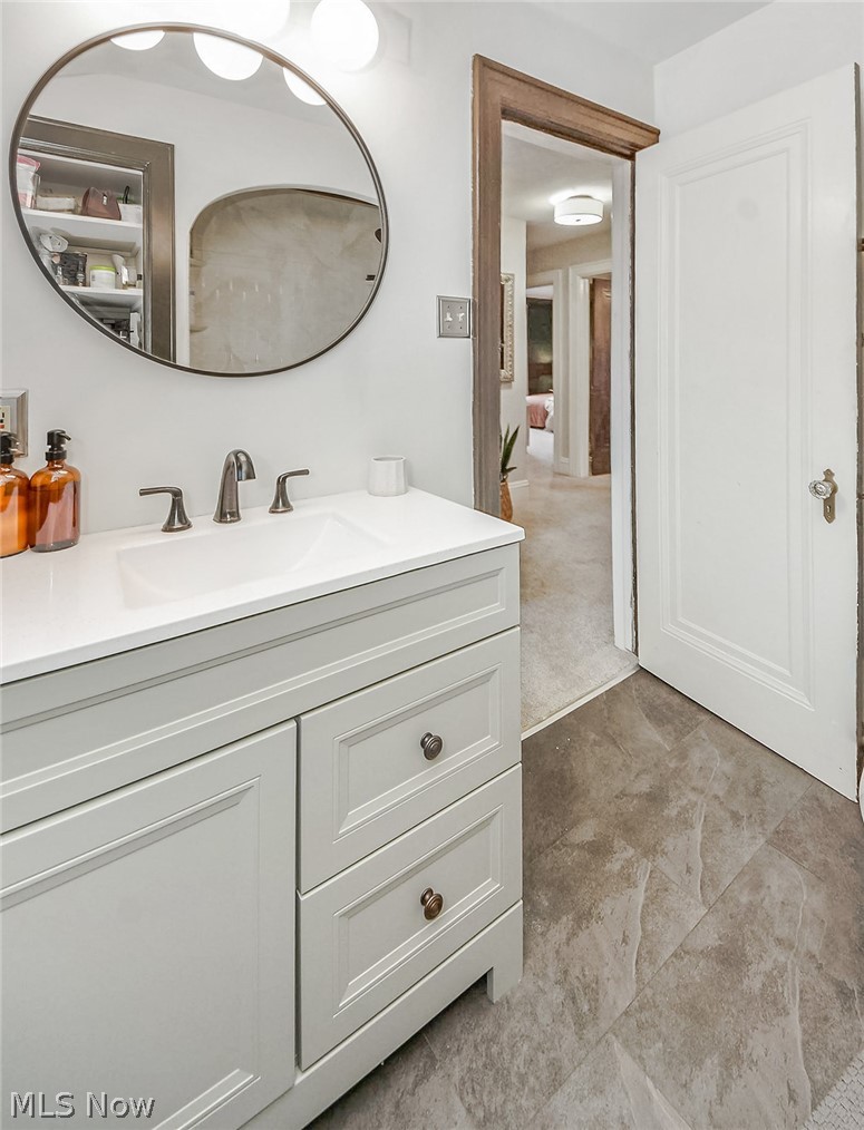 715 Ecton Road Akron, OH 44303 - Photo 16 of 30 The primary hallway bath has been completely updated; flooring, cabinetry, lighting, mirror, paint, tub surround, and toilet. Nothing to do.