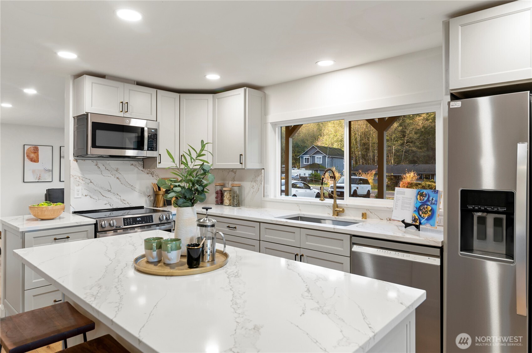 20909 Frank Waters Road Stanwood, WA 98292 - Photo 8 of 24 a kitchen with stainless steel appliances a microwave a sink and cabinets