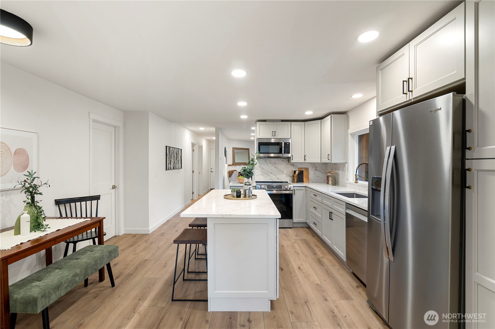 20909 Frank Waters Road Stanwood, WA 98292 - Photo 9 of 24 a kitchen with white cabinets and stainless steel appliances