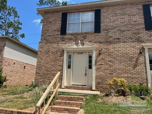 10154 Vixen Place Pensacola, FL 32514 - Photo 1 of 12 a front view of a house with stairs