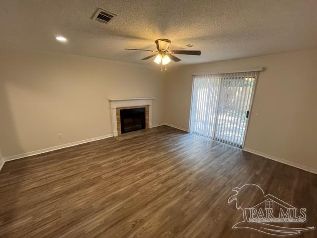 10154 Vixen Place Pensacola, FL 32514 - Photo 5 of 12 an empty room with wooden floor chandelier fan and windows