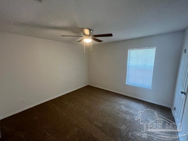 10154 Vixen Place Pensacola, FL 32514 - Photo 8 of 12 an empty room with a ceiling fan and a window