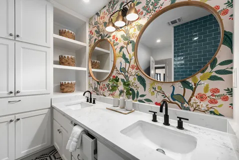 a bathroom with double vanity sink and a mirror