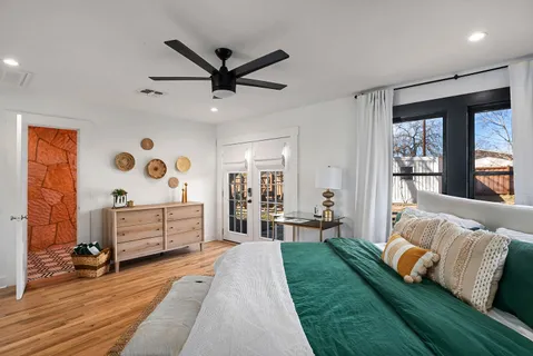 a bedroom with a bed and wooden floor