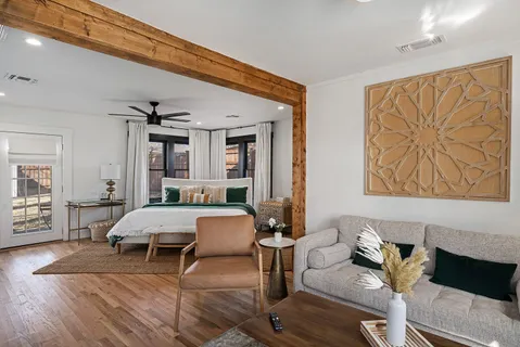 a living room with furniture and wooden floor