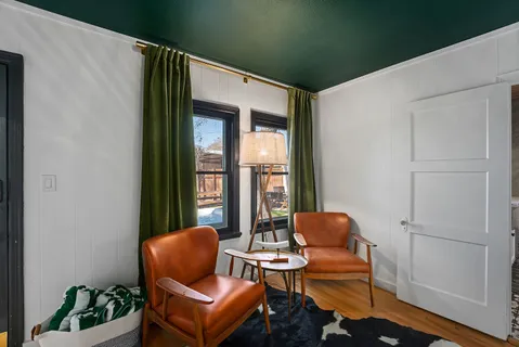 a living room with furniture and a potted plant