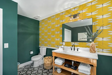 a bathroom with a sink mirror vanity and toilet