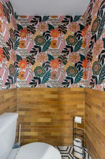 a bathroom with a toilet and a shower curtain