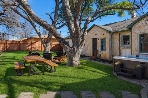 a view of a house with backyard and sitting area