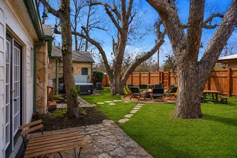a view of a house with backyard front of house