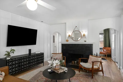a living room with furniture a fireplace and a flat screen tv