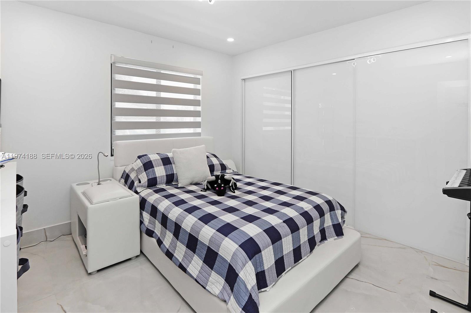 14211 Southwest 31st Street Miami, FL 33175 - Photo 11 of 15 a bedroom with a bed and a window