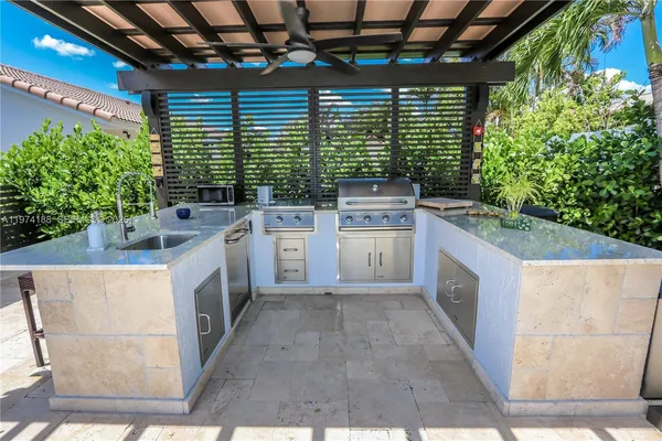 a kitchen with furniture a window and potted plants