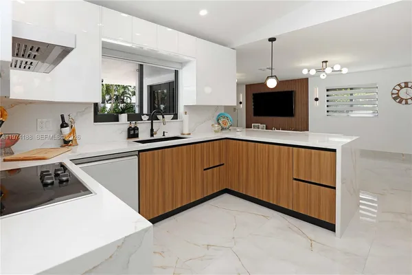 a kitchen with a sink a microwave and wooden cabinets