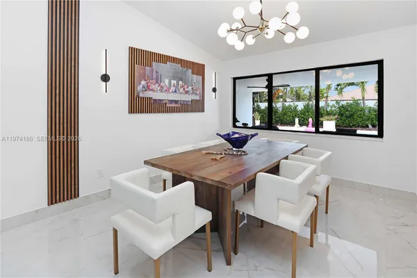 a view of a dining room with furniture a large window and a livingroom