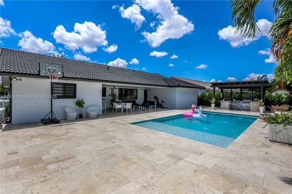 a view of a house with entertaining space and a tree