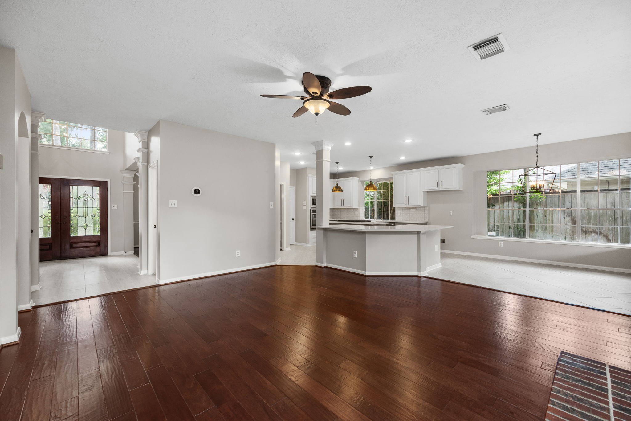 9015 Rhapsody Lane Houston, TX 77040 - Photo 19 of 39 Rich wood floors add warmth, while the wide-open design provides plenty of flexibility for furniture placement and creates a great space for gathering and entertaining.