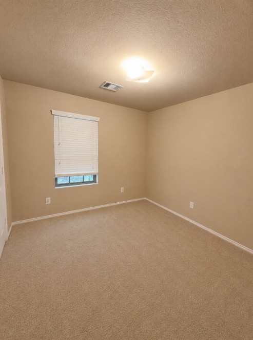 811 Lovebug Lane Conroe, TX 77301 - Photo 6 of 9 an empty room with a empty space and window