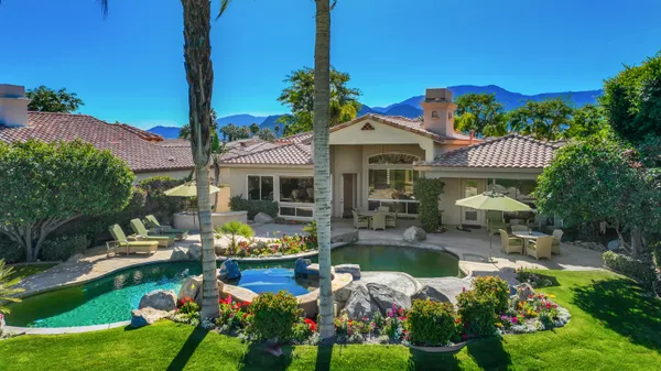 a view of a house with swimming pool garden and patio