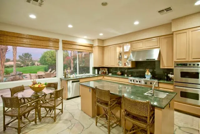 a kitchen with a table chairs stove and cabinets