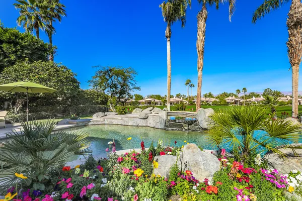 a kitchen with stainless steel appliances granite countertop a sink a counter space and cabinets