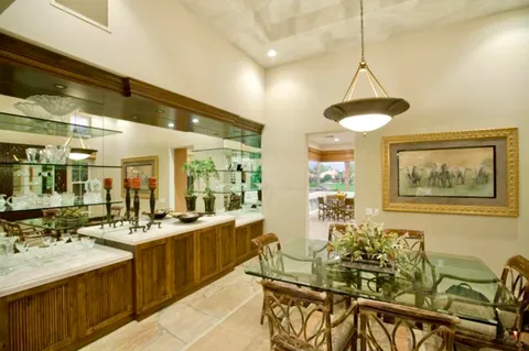 a very nice looking dining room with a large window and chandelier