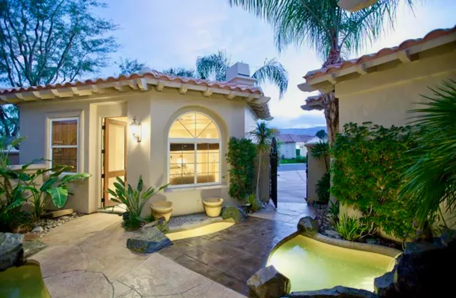 a view of a house with swimming pool patio and a garden