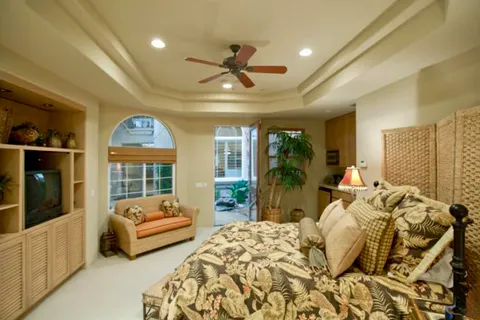 a bedroom with furniture and a large window