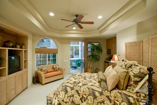 a bedroom with furniture and a large window