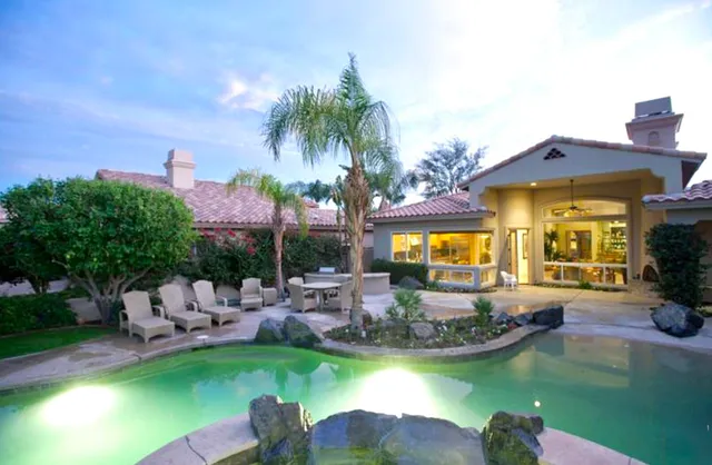 a view of a house with swimming pool and a yard