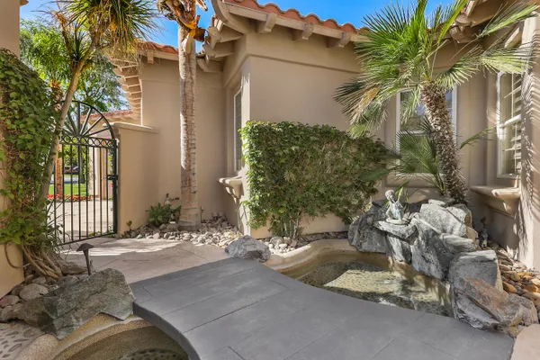 a front view of a house with swimming pool having outdoor seating