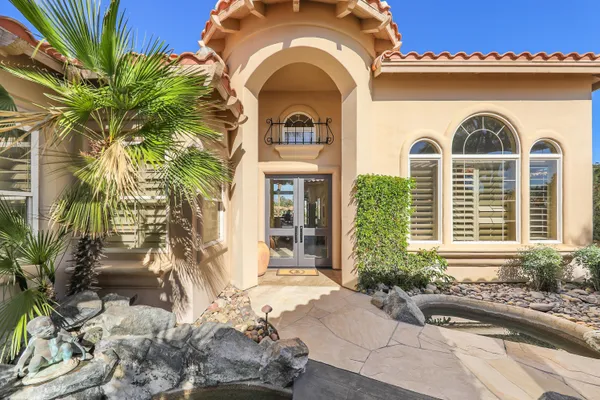 a view of a garden with plants and a fountain