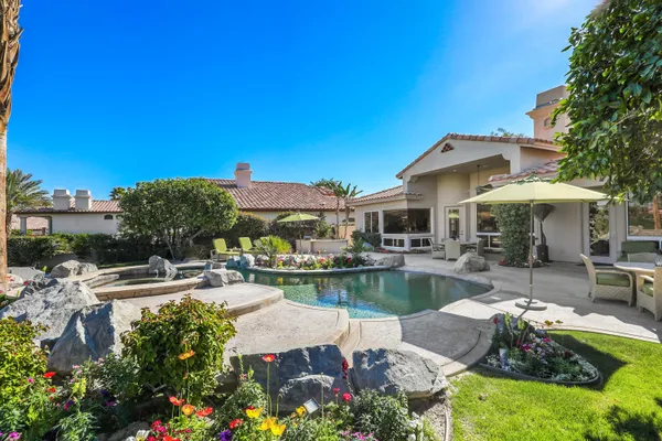 a view of a patio with couches chairs and a fire pit