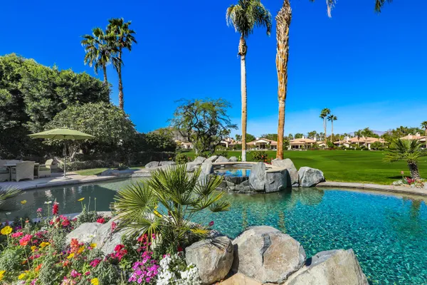 a living room with furniture a table and a painting