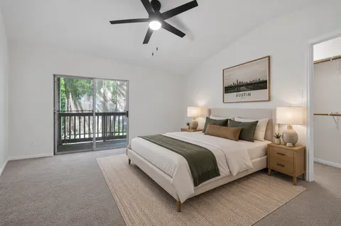 a spacious bedroom with a bed and a large window