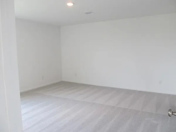 an empty room with a ceiling fan