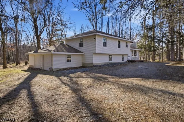 a view of a house with a yard covered in snow