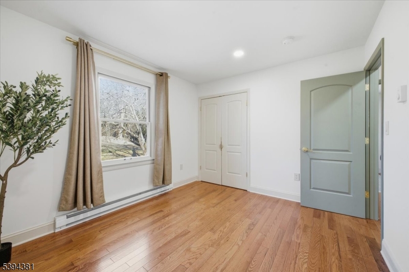 192 Bryans Road Hampton, NJ 08827 - Photo 16 of 38 a view of empty room with wooden floor and fan