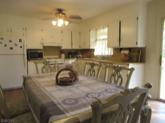 a kitchen with a table chairs and a stove