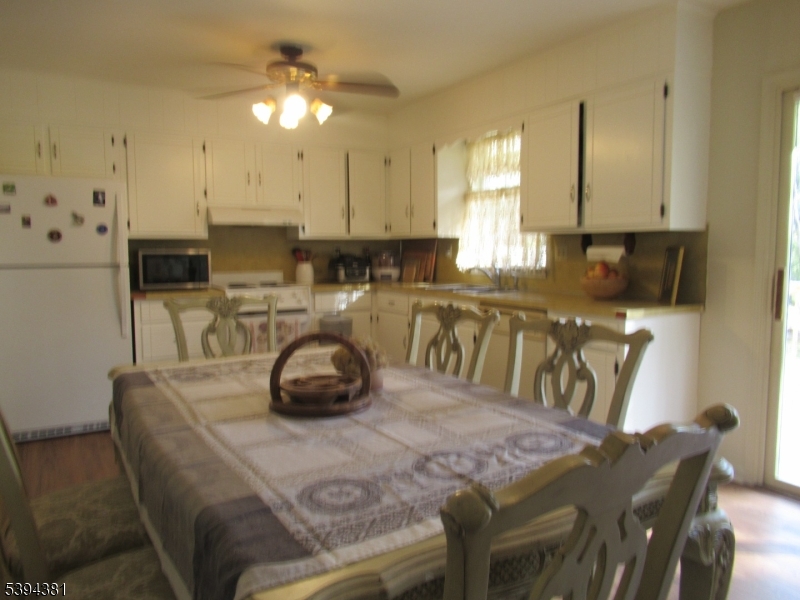 192 Bryans Road Hampton, NJ 08827 - Photo 16 of 32 a kitchen with a table chairs and a stove