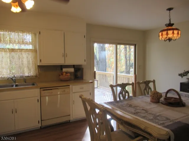 a kitchen with a table chairs stove and cabinets