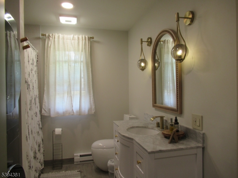 192 Bryans Road Hampton, NJ 08827 - Photo 27 of 32 a bathroom with a toilet sink and mirror