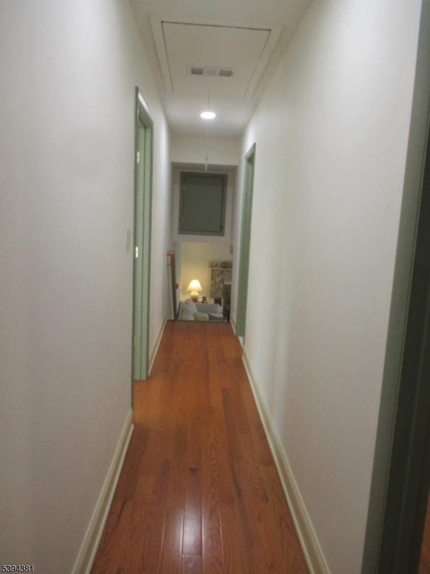 192 Bryans Road Hampton, NJ 08827 - Photo 29 of 32 a view of a hallway with wooden floor and a bathroom