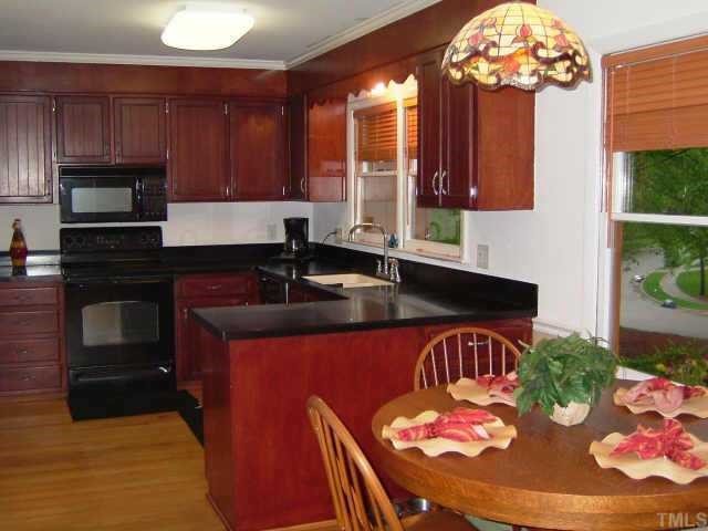 6203 Lookout Loop Raleigh, NC 27612 - Photo 2 of 11 a kitchen with a sink refrigerator and microwave