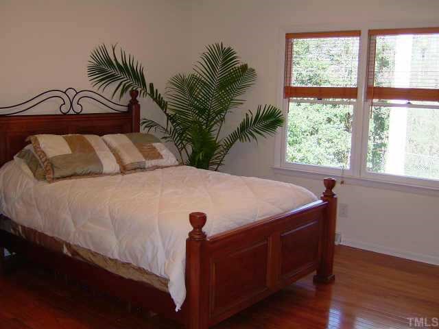 6203 Lookout Loop Raleigh, NC 27612 - Photo 3 of 11 a bedroom with a bed and a large window
