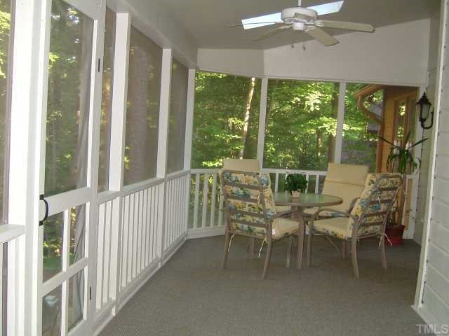 6203 Lookout Loop Raleigh, NC 27612 - Photo 9 of 11 a dining room with furniture large windows and a chandelier