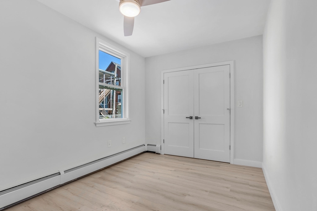74 Ruthven Street, Unit 1 Boston, MA 02121 - Photo 6 of 11 wooden floor in an empty room