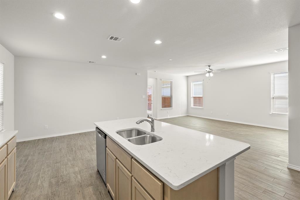 1713 Teton River Drive Blue Ridge, TX 75424 - Photo 12 of 29 a kitchen with a sink a kitchen island with wooden cabinets
